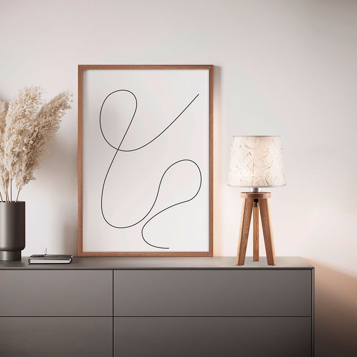 Dreibein Tischleuchte Naturart aus Asteiche geölt, Modell Elli, Schirm Almwiesenheu, Kabel im Bein verlaufend, Milieubild im Wohnzimmer, Leuchte steht auf Kommode 