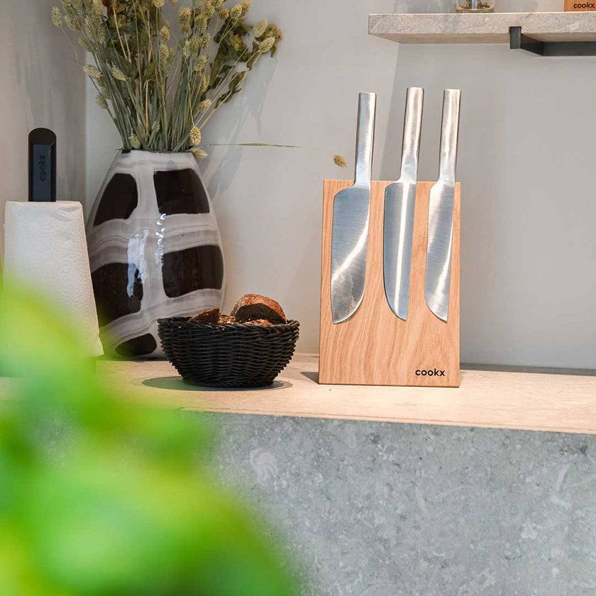 Messerblock aus Eichenholz Natur, magnetisch, Messerblock schräg nach hinten geneigt, Milieubild in Küche, drei Messer am Messerblock 
